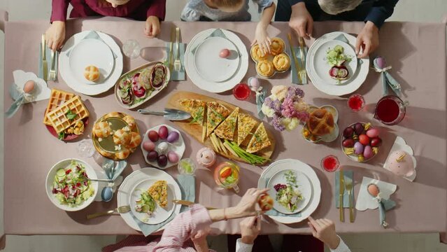 Top down shot of family sharing food while having holiday dinner on Easter day at home