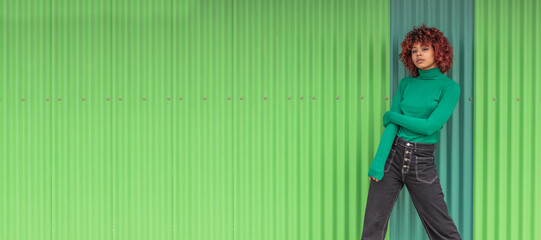urban girl on the street with green wall background