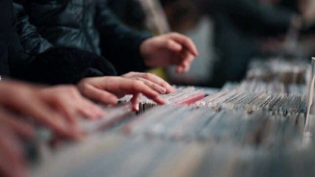 Man hands searching through the records at a vintage vinyl shop