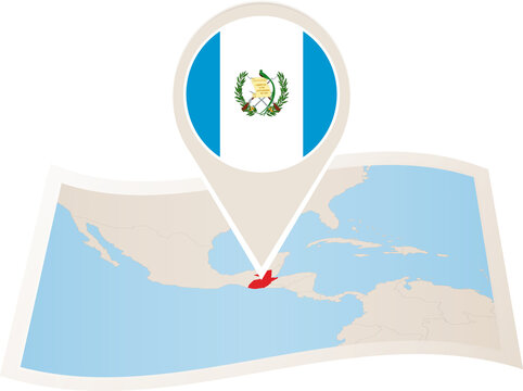 Folded paper map of Guatemala with flag pin of Guatemala. 