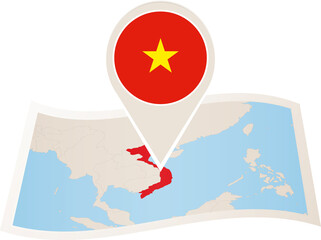 Folded paper map of Vietnam with flag pin of Vietnam.