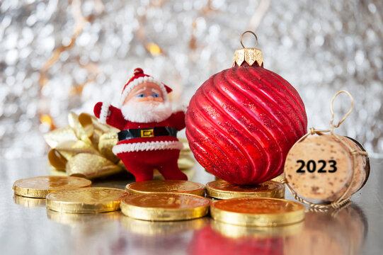 New Year background with champagne cork, santa claus model and chocolate coins, greeting card