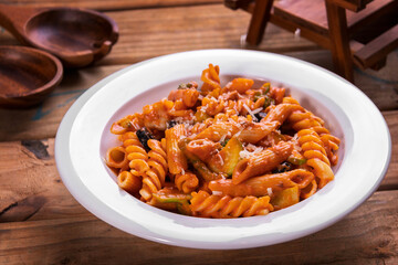 Red pasta served in dish top view on dark background american fast food