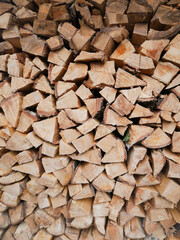 Chopped wood ready for use, Preparation of firewood for the winter. Pile of Firewood.Firewood background