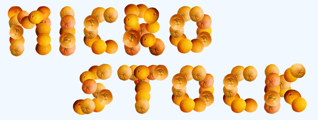 
Text showing the word "microstock" made of oranges, mandarines and tangerines. Slogan concept. Seasonal first fruits. Top view, flat lay, copy space, banner.