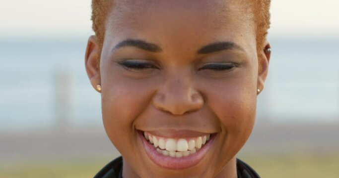 Black woman, smile and face while outdoor in nature with makeup, cosmetics and happiness for freedom, peace and funny humor. Portrait of African model laughing with perfect teeth and positive energy