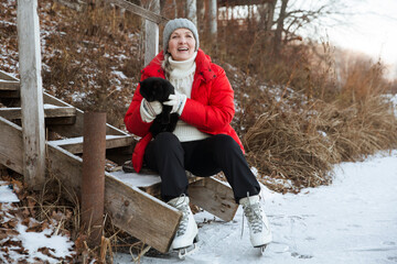 cheerful senior woman  ice skating on a frozen lake  in winter nature. Enjoying the little things....