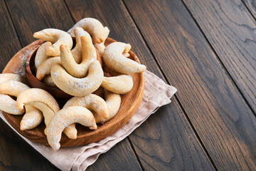 Christmas cookies crescents. Homemade traditional Christmas cookies Vanilla crescents in rustic plate with christmas decorations on old wooden rustic background. Food pattern. Holiday baking concept.