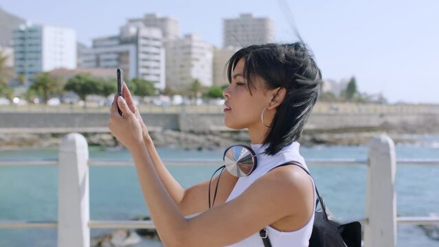 Beach, travel and woman recording phone video for memory of summer holiday in Brazil. Ocean, sun and vacation girl with smartphone screen to capture nature, city and outdoor walk with focus.