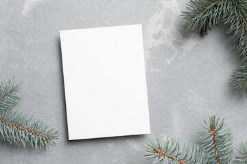 Blank greeting card mockup with fir tree branches