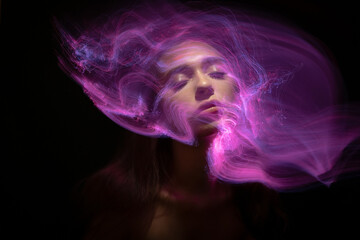 Abstract photography in the style of light painting. girl on a black background