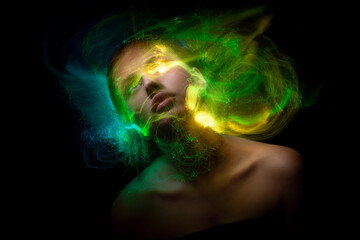 Abstract photography in the style of light painting. girl on a black background