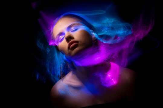 Abstract photography in the style of light painting. girl on a black background