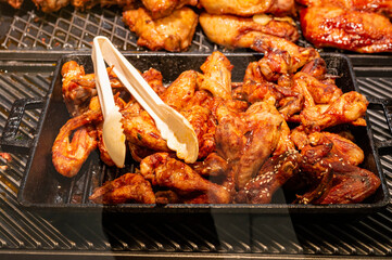 fried chicken wings on the shelves of stores close-up