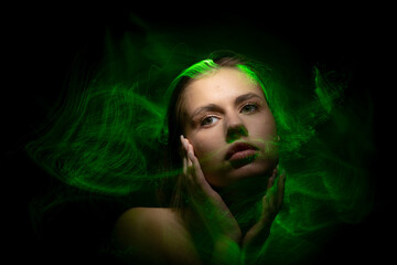 Abstract photography in the style of light painting. girl on a black background