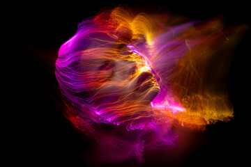 Abstract photography in the style of light painting. girl on a black background