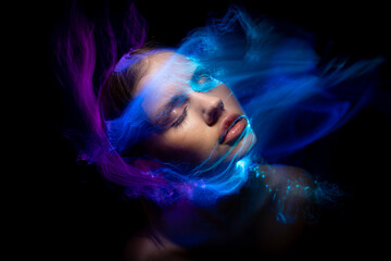 Abstract photography in the style of light painting. girl on a black background