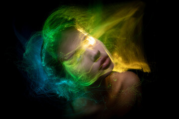 Abstract photography in the style of light painting. girl on a black background