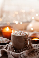 warm cozy window arrangement, winter or autumn concept, coffe, candles throw lights