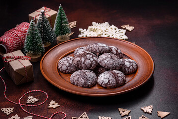 Delicious fresh brownies with Christmas decorations on a dark concrete background
