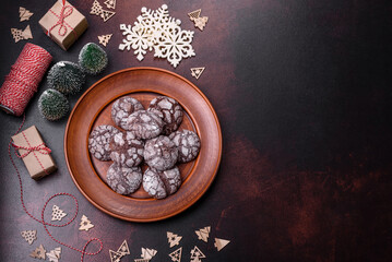 Delicious fresh brownies with Christmas decorations on a dark concrete background