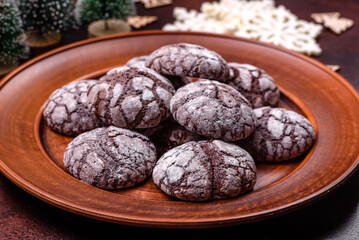 Delicious fresh brownies with Christmas decorations on a dark concrete background
