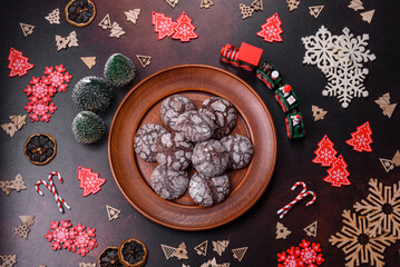 Delicious fresh brownies with Christmas decorations on a dark concrete background