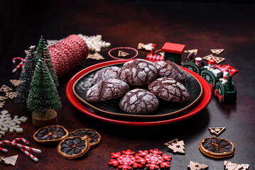 Delicious fresh brownies with Christmas decorations on a dark concrete background