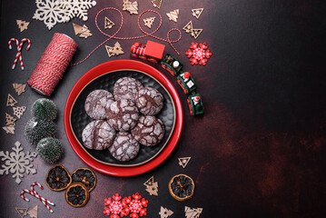 Delicious fresh brownies with Christmas decorations on a dark concrete background