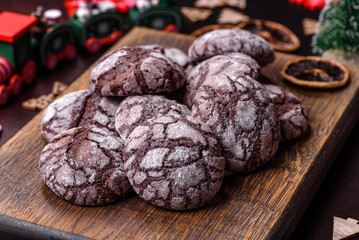 Delicious fresh brownies with Christmas decorations on a dark concrete background