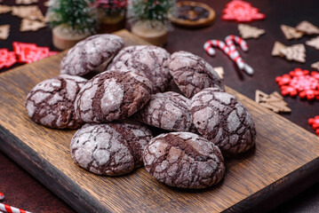 Delicious fresh brownies with Christmas decorations on a dark concrete background