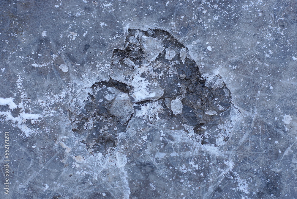 Wall mural natural texture of gray dirty pieces of ice and water in the pond