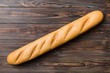 Minimalist french baguette on colored background. fresh bread as background, top view with space for your text or design