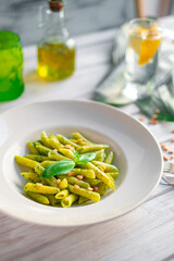 Penne pasta with pesto sauce, basil and pine nuts. Classic Italian pasta recipe