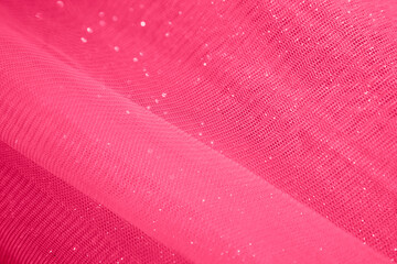 red fabric background from organza, tulle, silk. Abstract background with glitter. viva magenta.