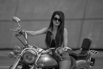 Fototapeta na wymiar Portrait of young woman with motorcycle