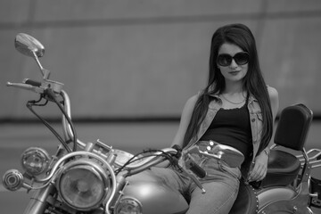 Fototapeta na wymiar Portrait of young woman with motorcycle