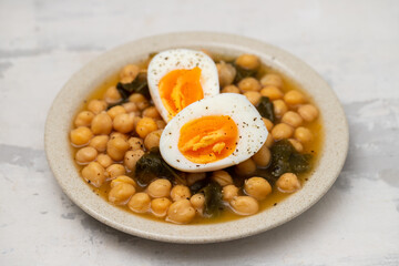 Boiled chickpea with spinach and boiled egg on plate