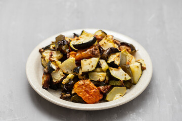 Mixed baked vegetables on light brown dish