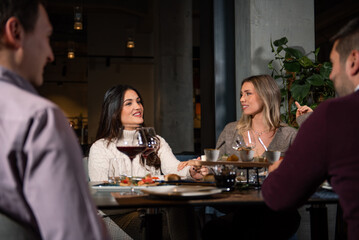 Group of Happy friends having lunch in the restaurant
