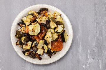 Mixed baked vegetables on light brown dish
