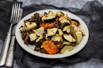 Mixed baked vegetables on light brown dish