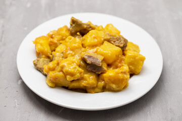 Beef stew with sweet potato and curry sauce on plate