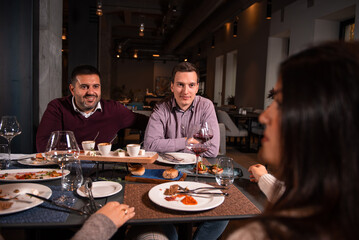 Group of Happy friends having lunch in the restaurant