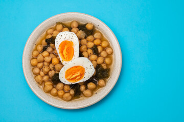 Boiled chickpea with spinach and boiled egg on plate