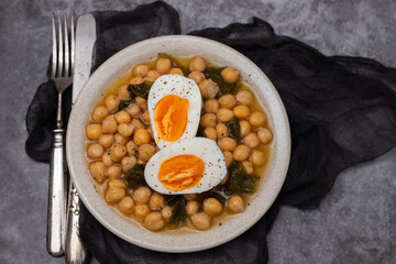 Boiled chickpea with spinach and boiled egg on plate