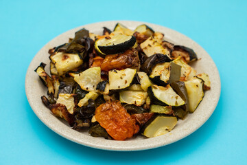 Mixed baked vegetables on light brown dish