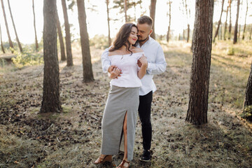 Fototapeta premium Young couple in love walking in the park