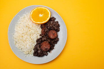 Typical brazilian food beans with sausages and rice Feijoada on white dish