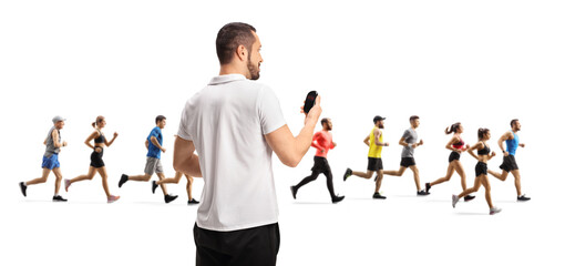 People running and a coach measuring time with a stopwatch